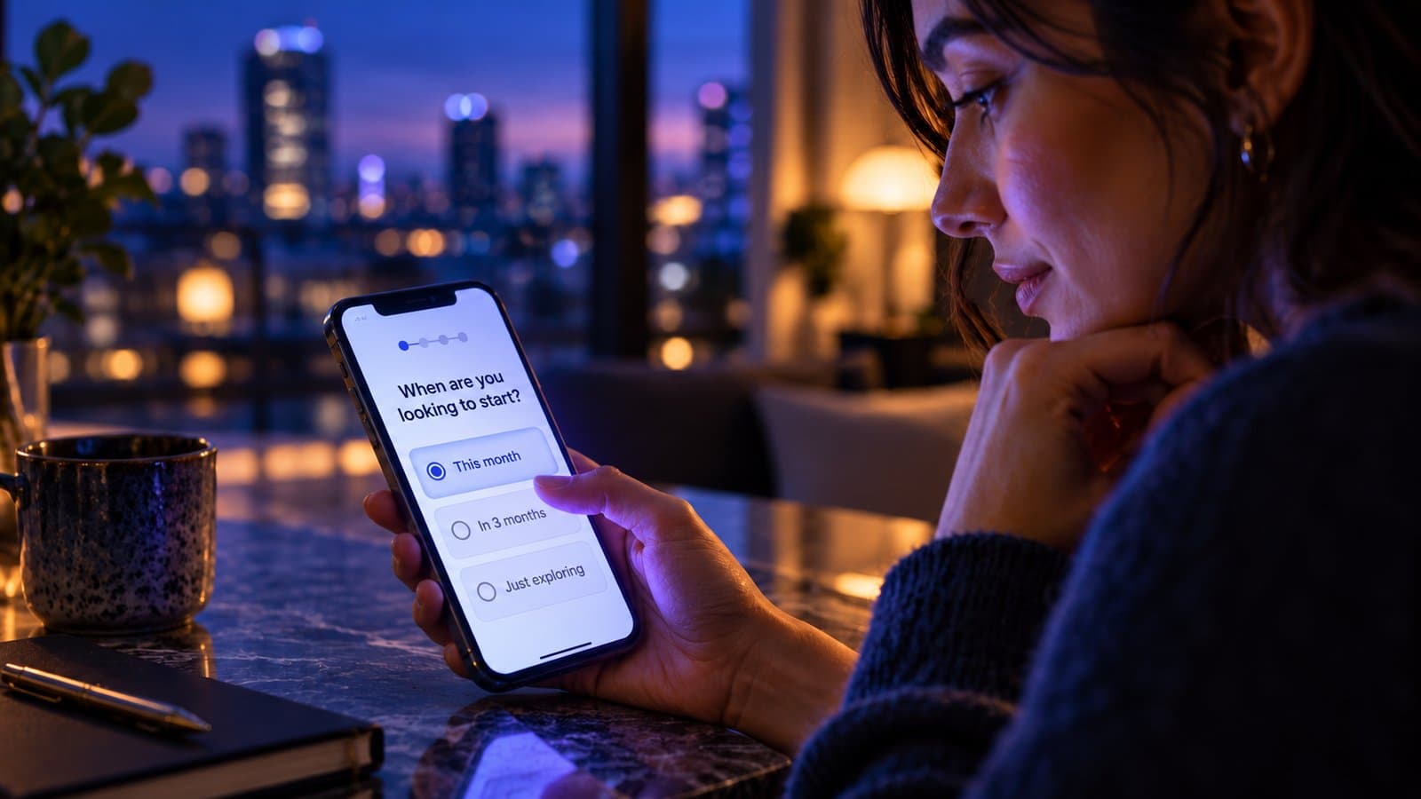 A woman at home in the evening answering a quiz question on her phone: when are you looking to start?